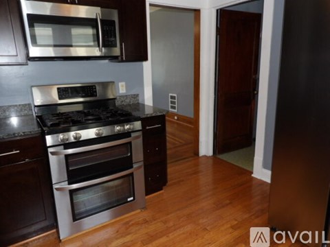 A kitchen with a stainless steel oven and microwave.