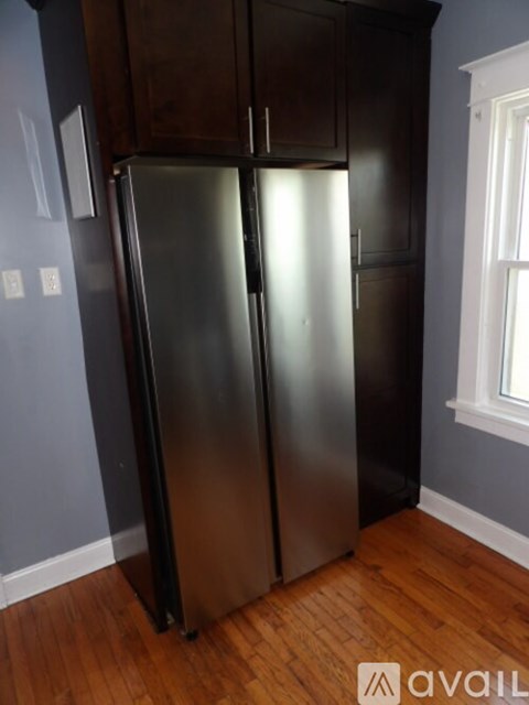 A stainless steel refrigerator in a kitchen.