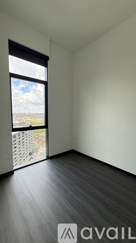 A room with a large window overlooking a balcony.