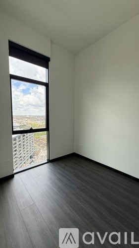 A room with a large window overlooking a balcony.