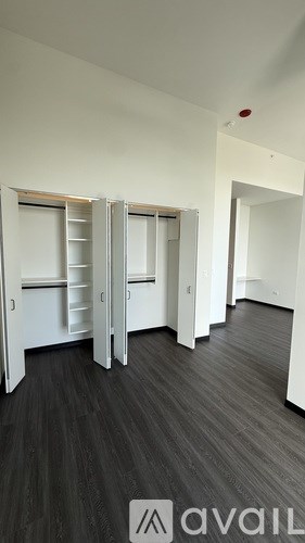 A room with a wooden floor and white walls.