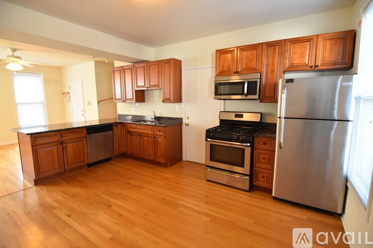 A kitchen with wooden cabinets and stainless steel appliances.