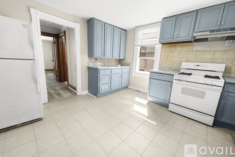 A kitchen with a white refrigerator and white stove.