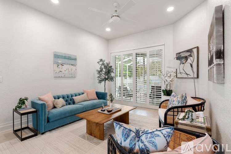 A living room with a blue couch and a wooden coffee table.