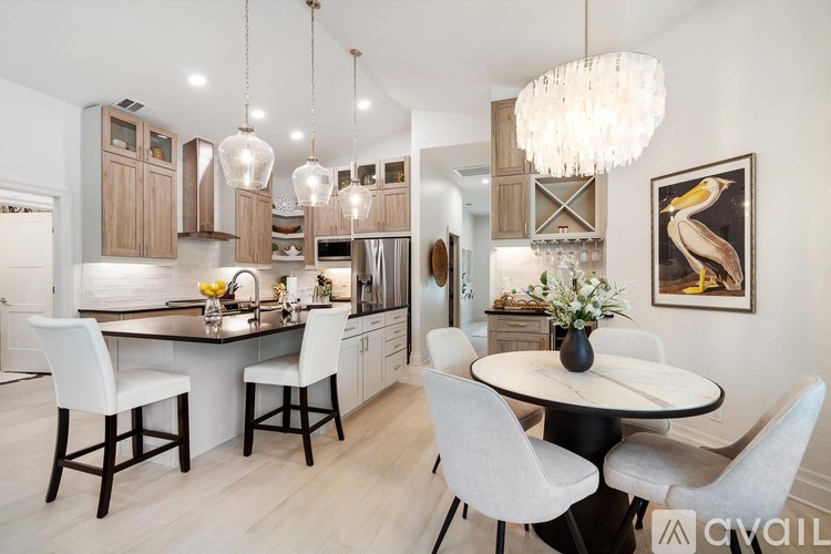 A modern kitchen with a dining table set for four.