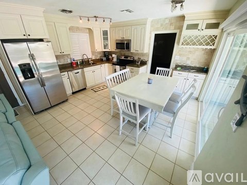 A kitchen with a table and chairs in the middle of the room.