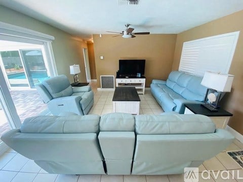 A living room with a large sectional sofa and a television.