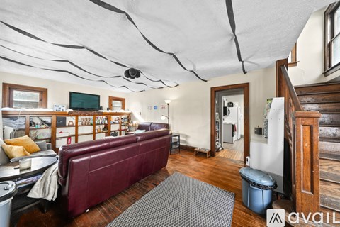 A living room with a red couch and a television.