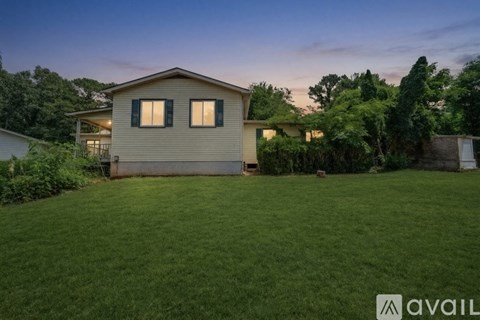A house with a lawn in front of it is available for rent.