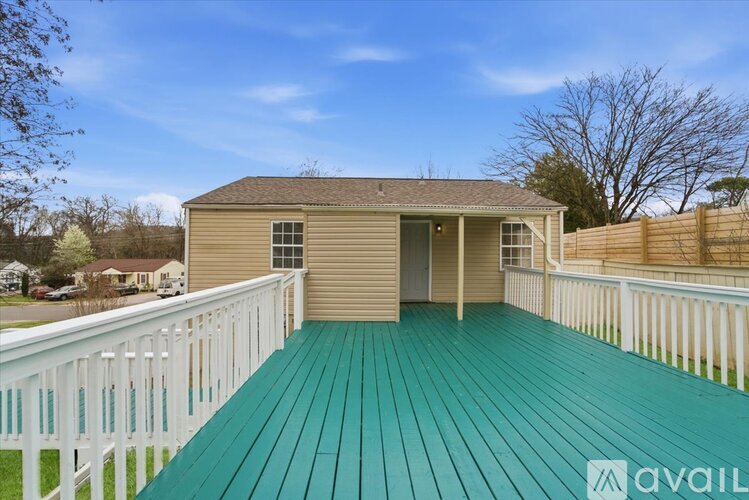 A house with a green deck is for sale.