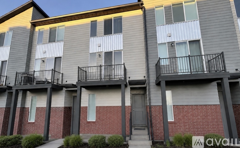 A row of apartment buildings with balconies and doors.