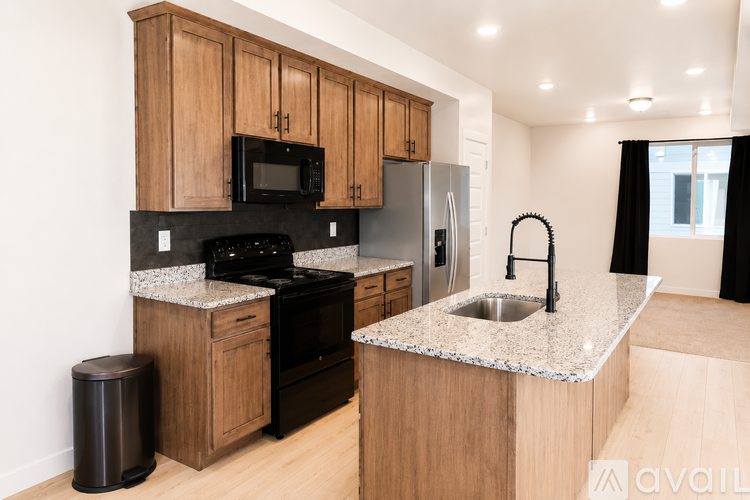 A kitchen with wooden cabinets and granite countertops.