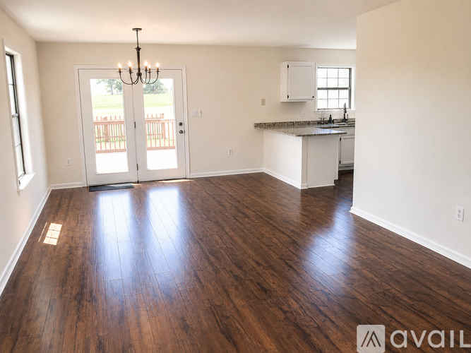 A room with wooden floors and a chandelier.