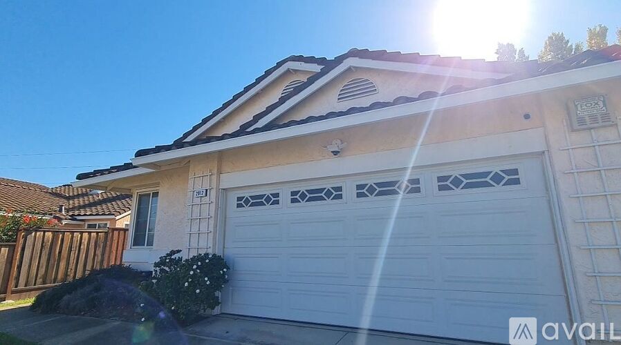 A house with a garage door that has a pattern on it.