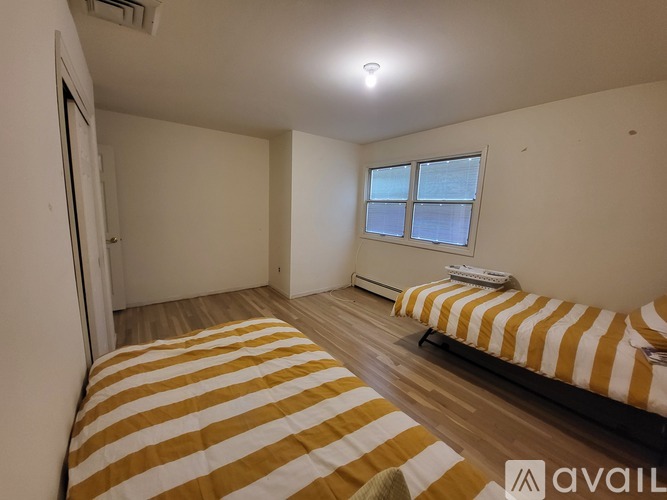 A bedroom with a bed and a window.