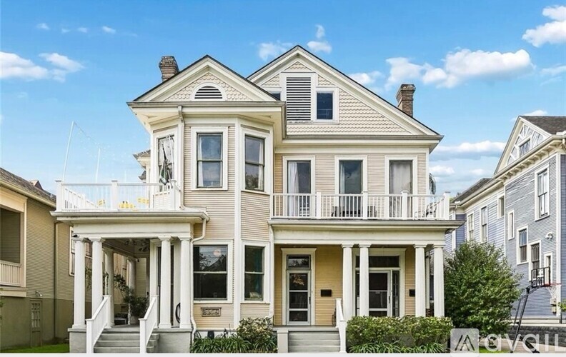 A two-story house with a balcony on the second floor.