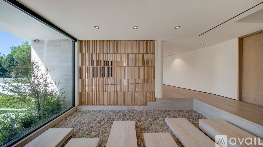 A modern interior space with a wooden partition and benches.