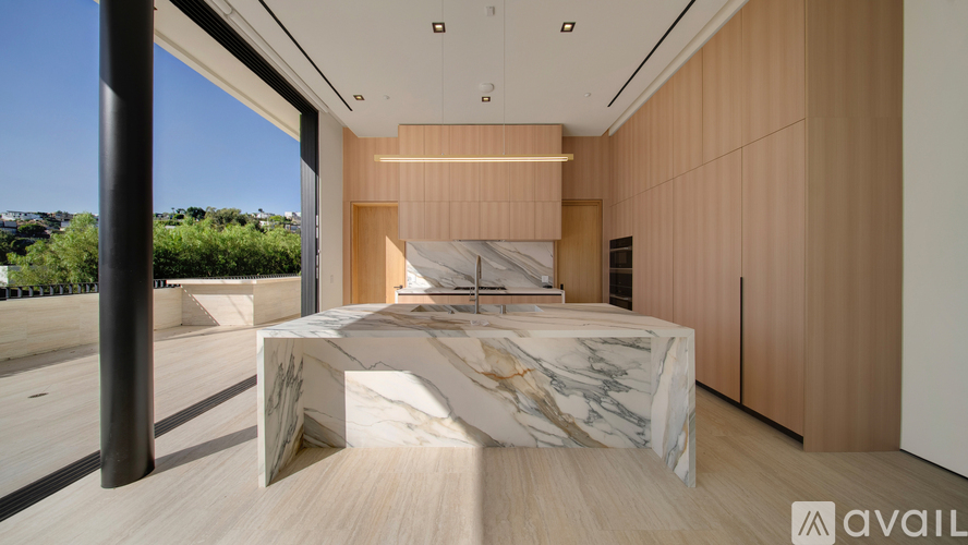A modern bedroom with a marble bed and wooden accents.