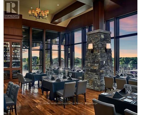 A dining room with a stone pillar and chairs.