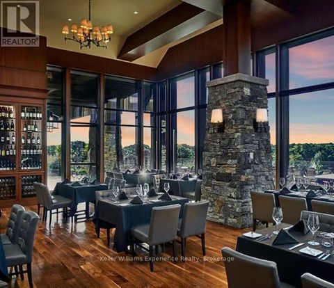 A dining room with a stone pillar and chairs.