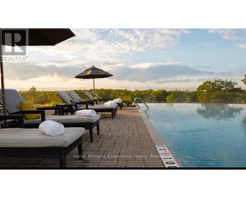 A poolside lounge area with sunbeds and umbrellas.