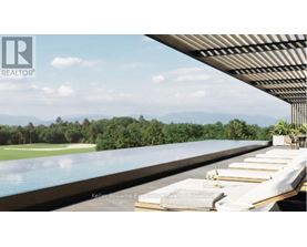 A pool with a view of the mountains and trees.