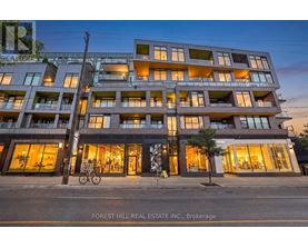 A modern apartment building with a bicycle parked in front.
