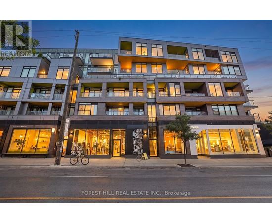 A modern apartment building with a bicycle parked in front.