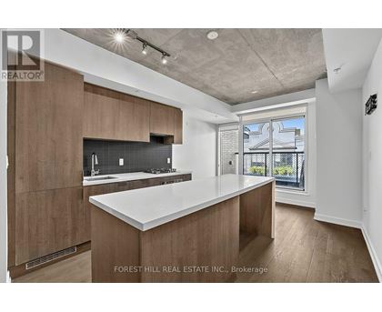 A modern kitchen with wooden cabinets and a large island.