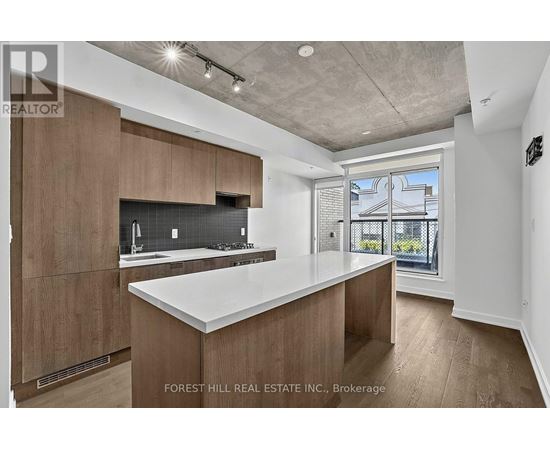 A modern kitchen with wooden cabinets and a large island.