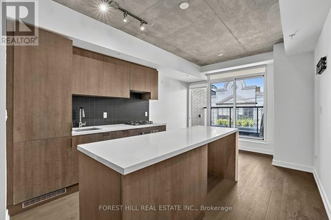 A modern kitchen with wooden cabinets and a large island.
