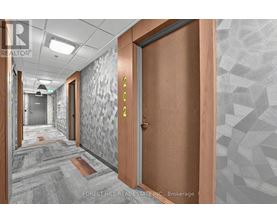 A hallway with a wooden door and a glass door with a number 4 on it.