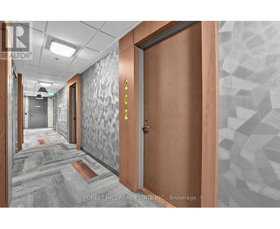A hallway with a wooden door and a glass door with a number 4 on it.
