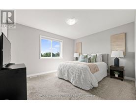 A bedroom with a large bed and a flat screen TV.