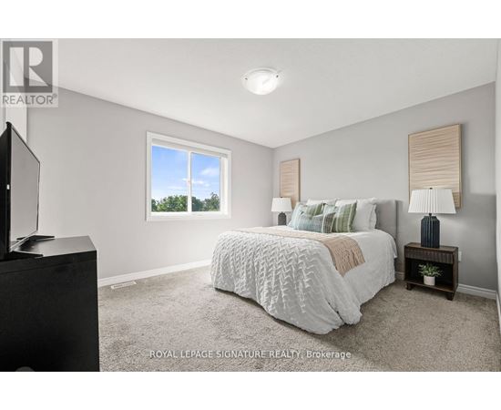 A bedroom with a large bed and a flat screen TV.