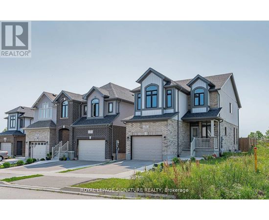 A large, multi-story house with a grey and white exterior is shown.