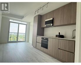 A modern kitchen with wooden cabinets and a stainless steel oven.