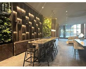 A modern dining area with a long table and chairs.