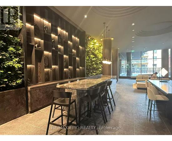 A modern dining area with a long table and chairs.