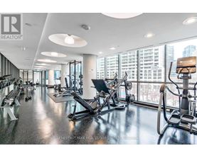 A gym with a view of the city outside the windows.