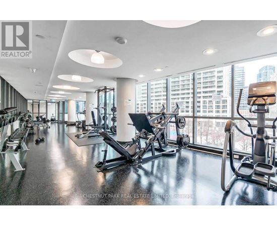 A gym with a view of the city outside the windows.