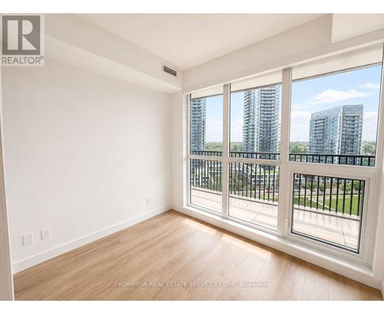 A room with a large window overlooking a cityscape.