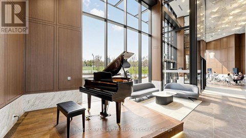 A grand piano sits in a spacious room with a view of the outdoors.