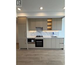 A kitchen with a stainless steel oven and a marble backsplash.