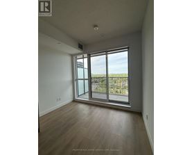 A room with a sliding glass door leading to a balcony.