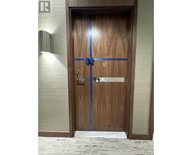 A wooden door with a blue ribbon across it.