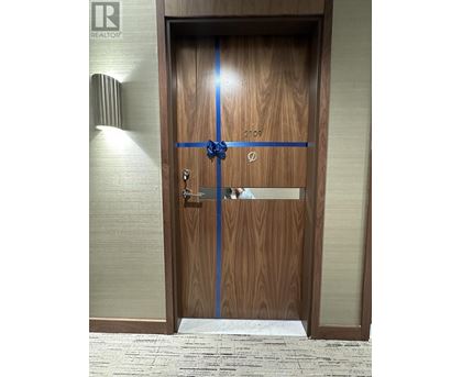 A wooden door with a blue ribbon across it.
