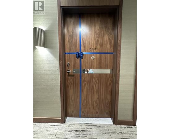 A wooden door with a blue ribbon across it.