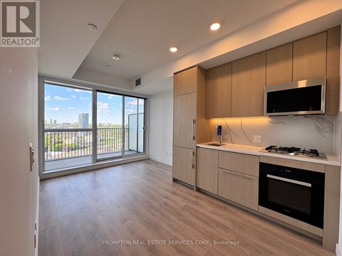 A kitchen with wooden cabinets and a stove top oven.