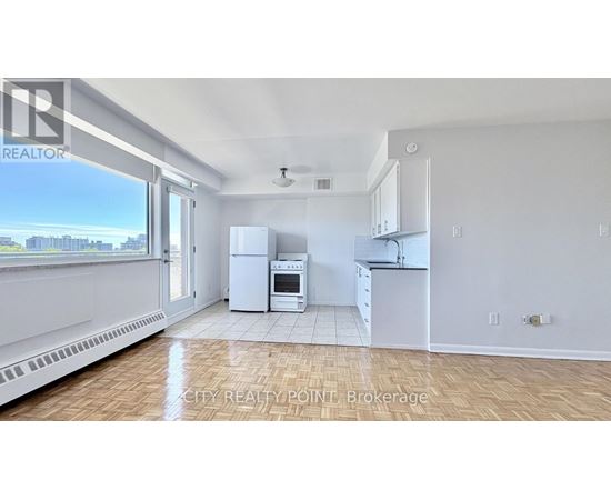 A realtor logo is on the top left of a photo of a kitchen.